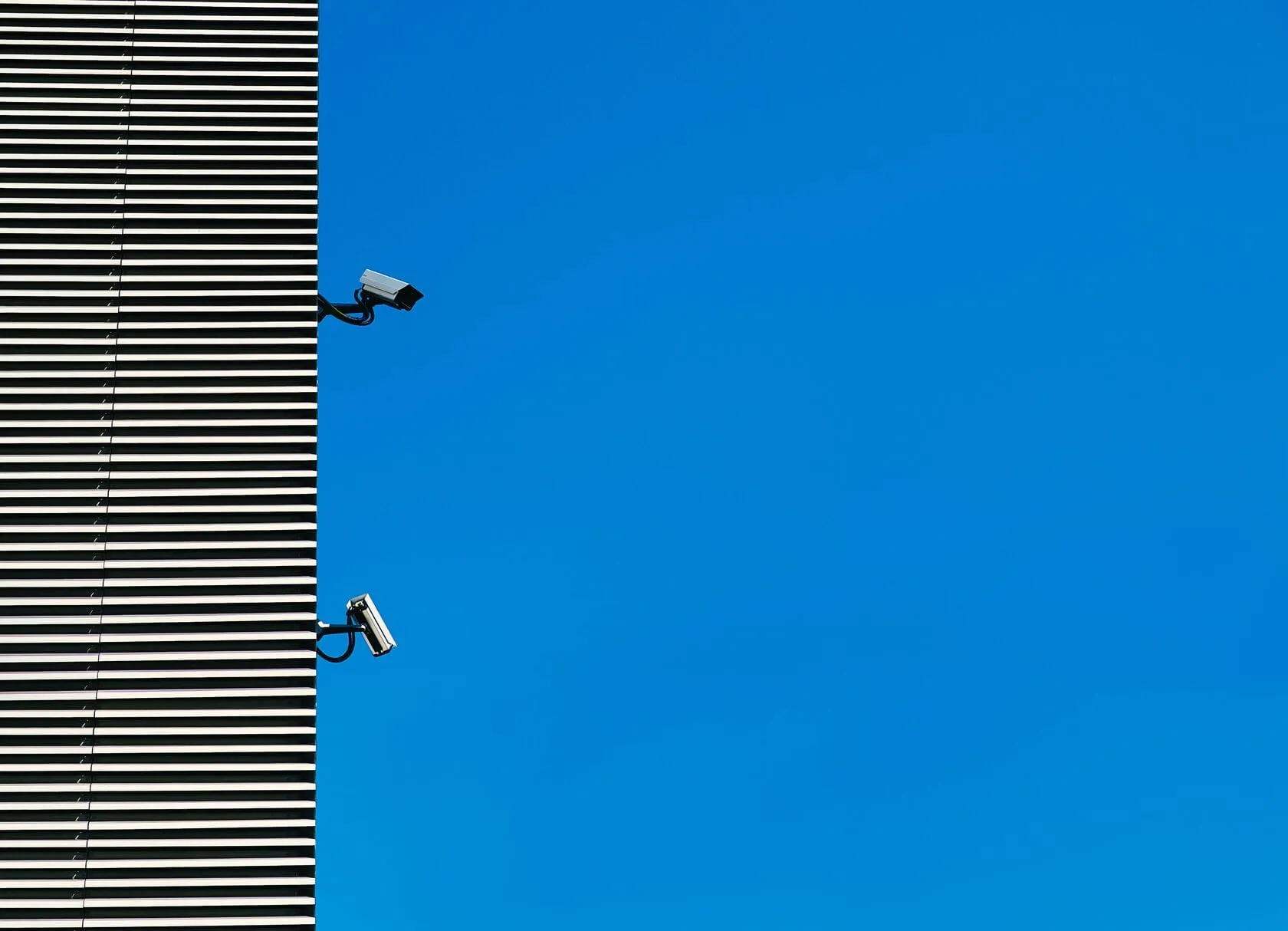 Security cameras on a dark facade